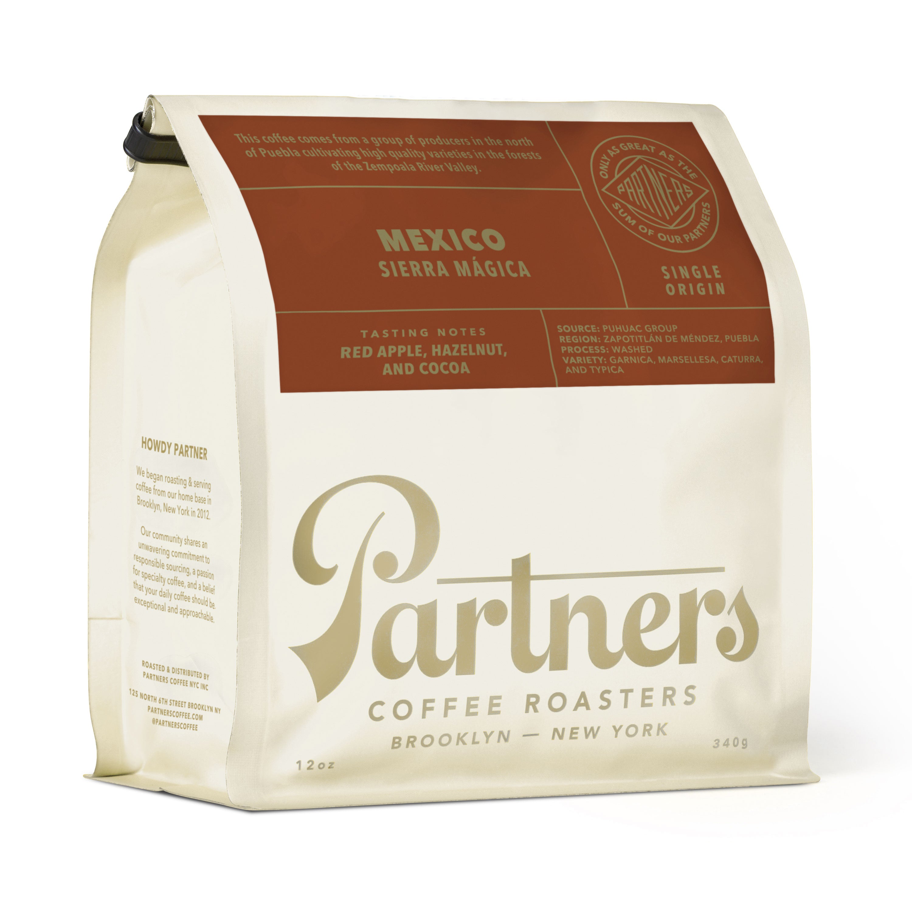 Angled view of 12-ounce Mexico Sierra Mágica coffee bag showcasing red apple, hazelnut, and cocoa tasting notes