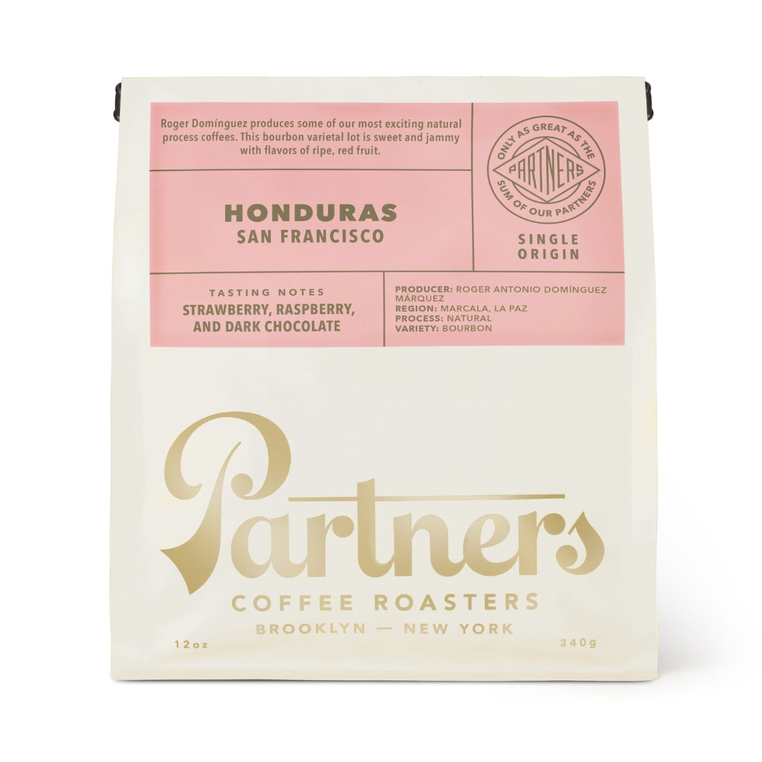 Front view of the 12oz Honduras San Francisco coffee bag showcasing its pink label on a white background