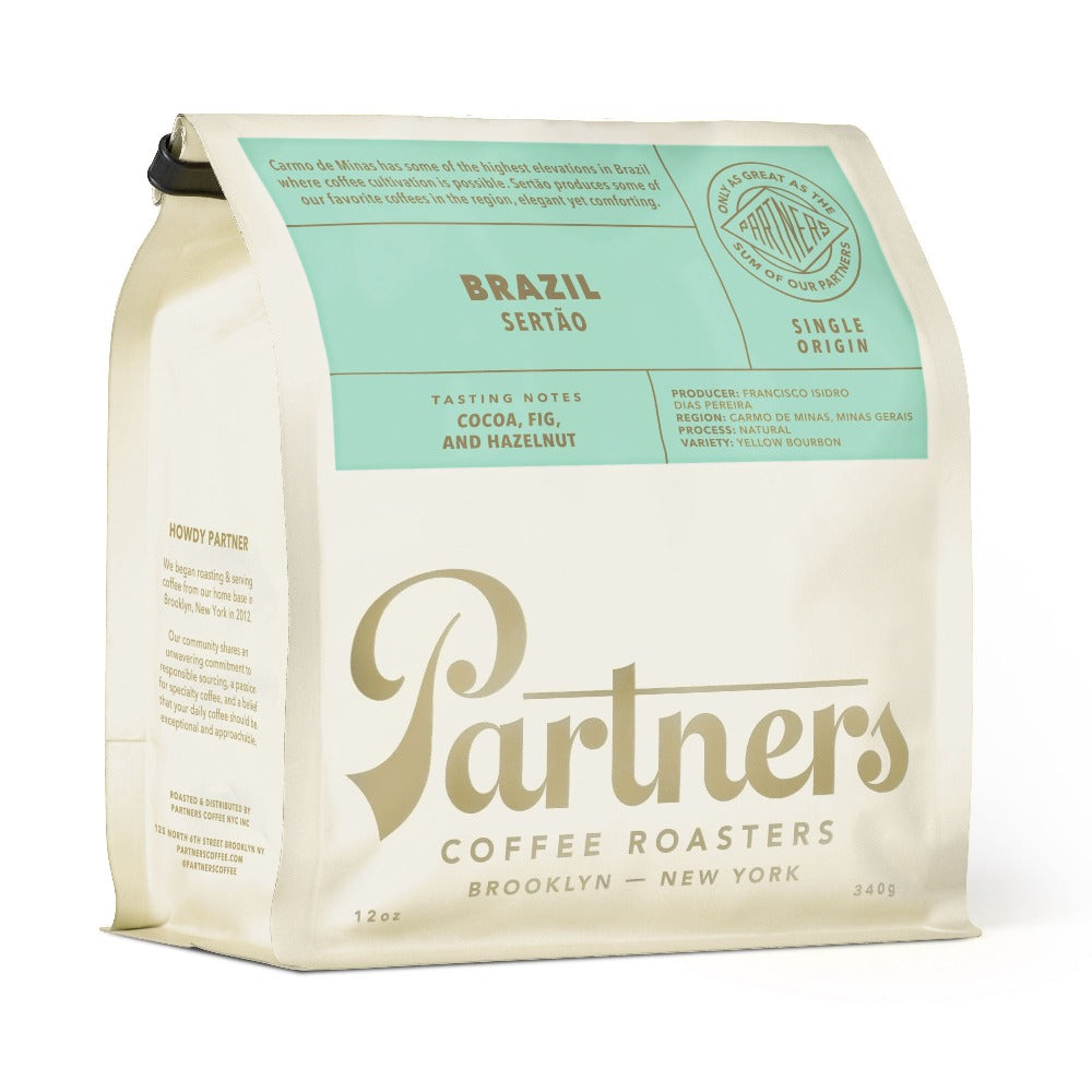 Angled view of the 12-ounce Brazil Sertão coffee bag featuring cocoa, fig, and hazelnut tasting notes on a white background