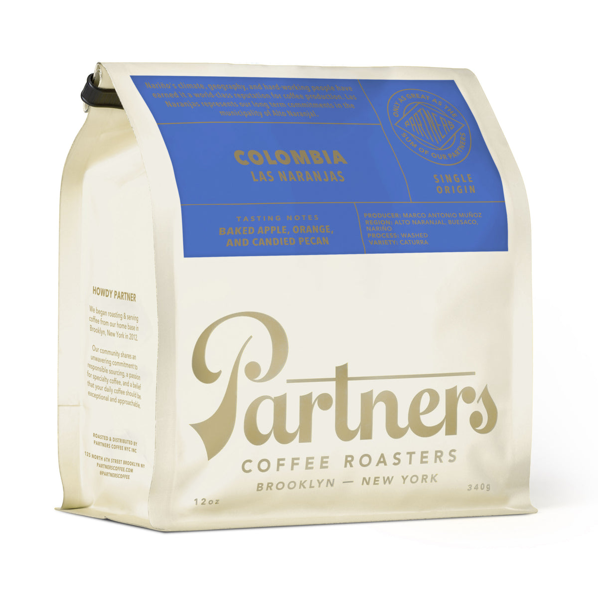 Angled view of Colombia Las Naranjas coffee bag showcasing blue label and tasting notes with a white background