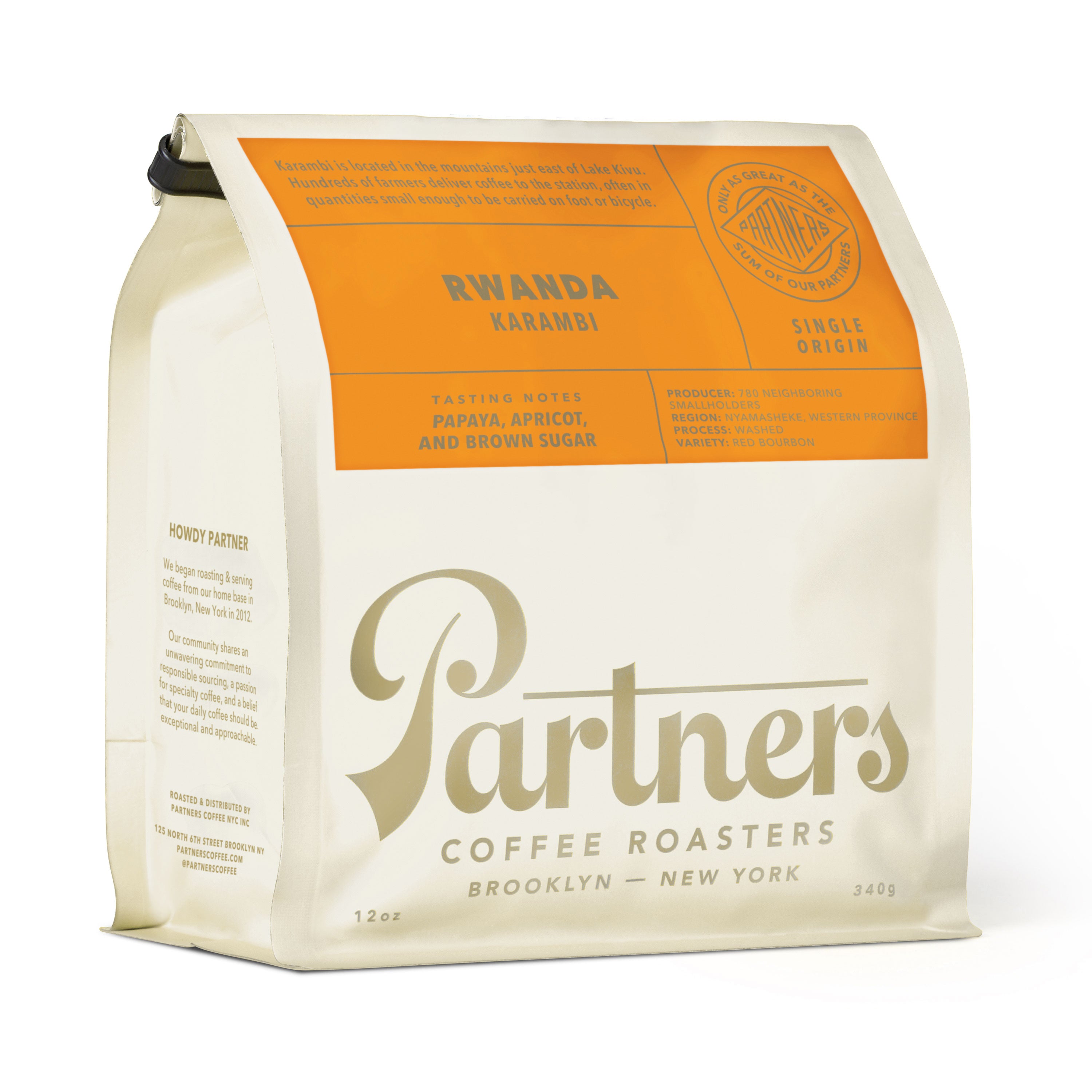 Angled view of 12 oz Rwanda Karambi coffee bag showcasing papaya, apricot, and brown sugar tasting notes on white background