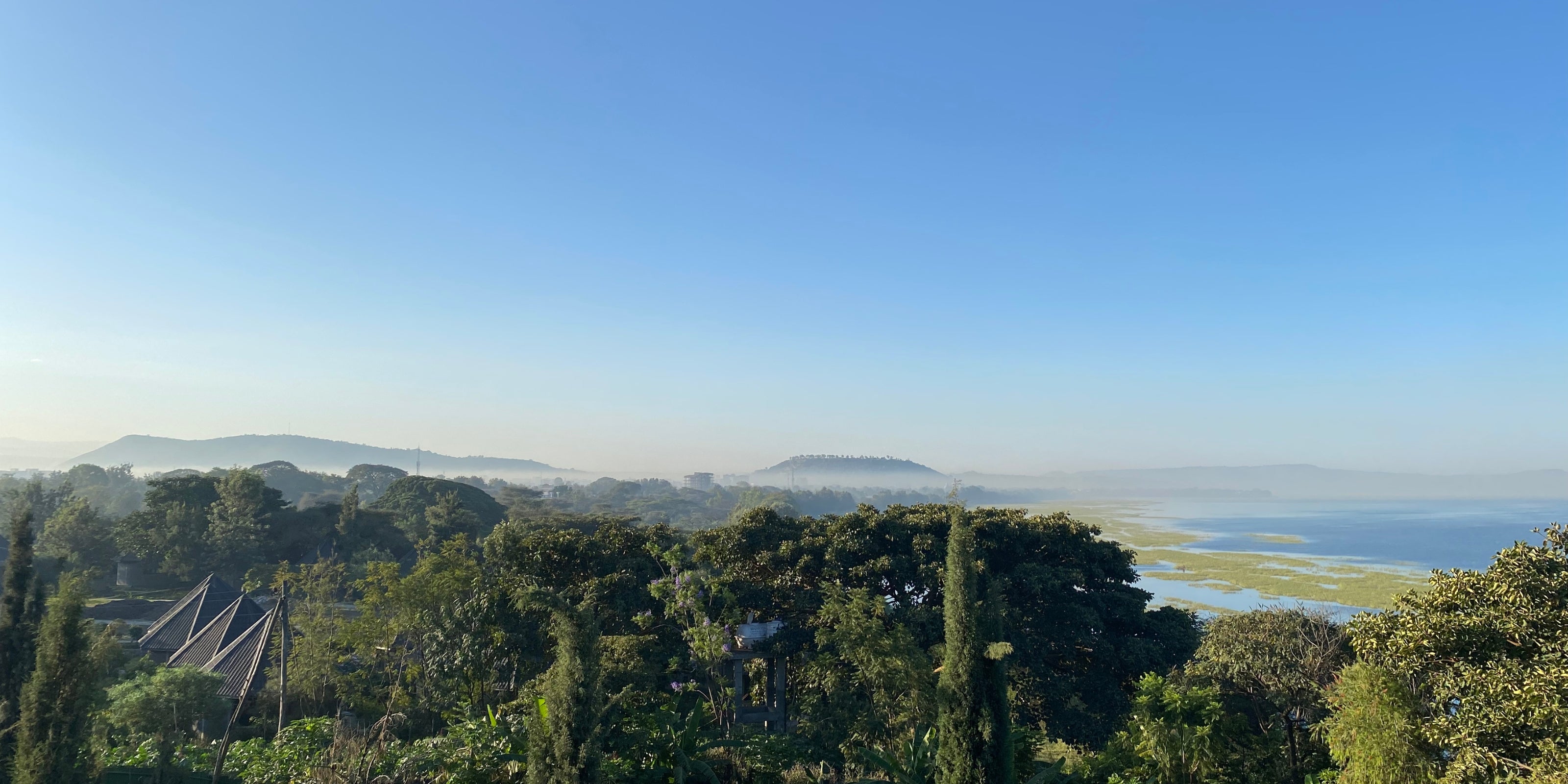 Panoramic view of Bensa, Sidama, Ethiopia, with lush vegetation, distant hills, and a broad lake