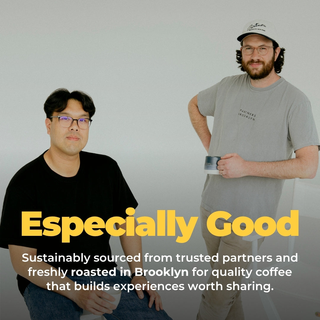 Two Partners Coffee team members pose with a coffee cup under Especially Good, promoting sustainably sourced coffee roasted in Brooklyn